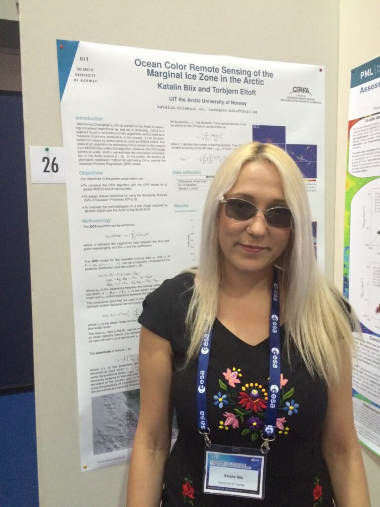 Katalin Blix in front of her poster at the CLEO conference.