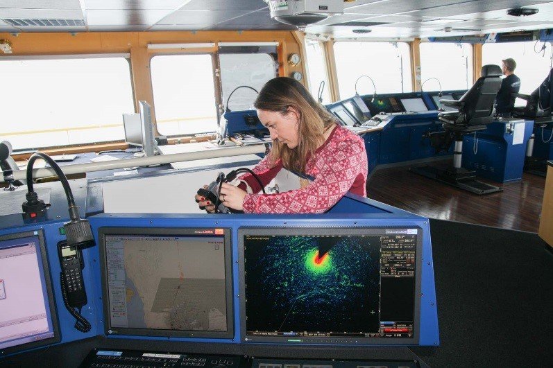 Figure 2 Skarbø checking the display cable connection between the radar operator station and her equipment, during the Arctic Ocean 2016 research cruise.